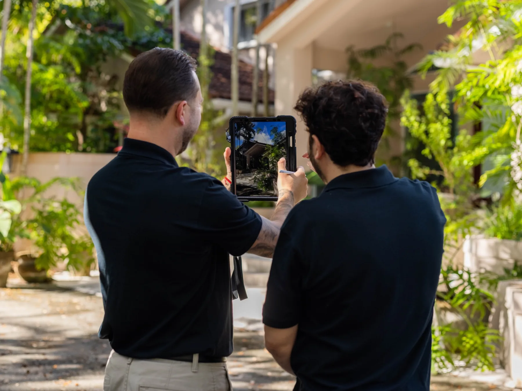 Trusted Watchers team member reviewing a clean tablet-based property inspection dashboard