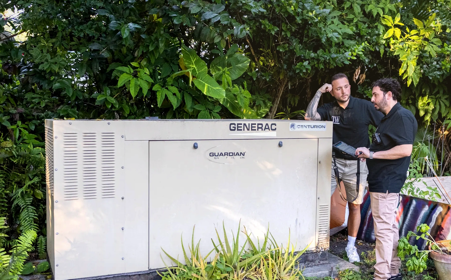 Trusted Watchers team reviewing a generator system on site